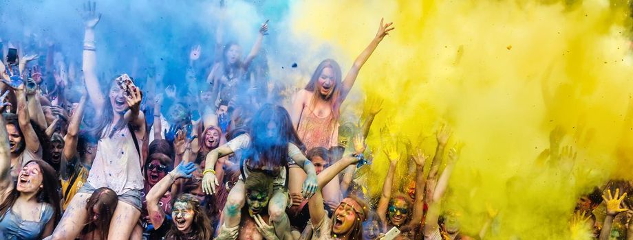 Holi colors holiday. Crazy crowd of young people having fun during festival of colors ColorFest in Kyiv, Ukraine