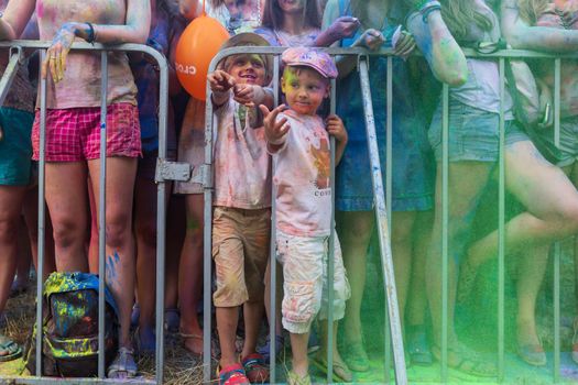 Holi colors holiday. Crazy crowd of young people having fun during festival of colors ColorFest in Kyiv, Ukraine