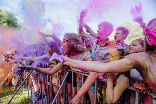 Holi colors holiday. Crazy crowd of young people having fun during festival of colors ColorFest in Kyiv, Ukraine