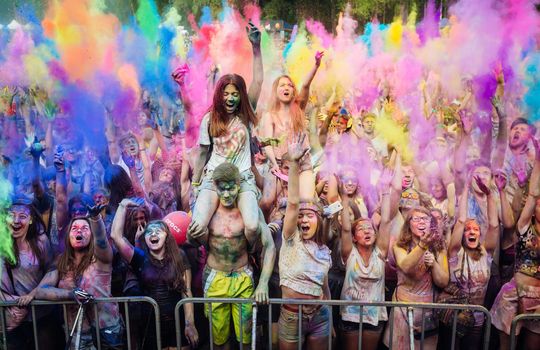 Holi colors holiday. Crazy crowd of young people having fun during festival of colors ColorFest in Kyiv, Ukraine