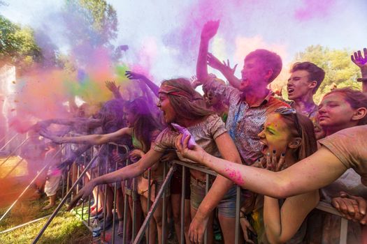 Holi colors holiday. Crazy crowd of young people having fun during festival of colors ColorFest in Kyiv, Ukraine