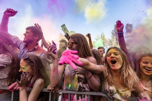 Holi colors holiday. Crazy crowd of young people having fun during festival of colors ColorFest in Kyiv, Ukraine