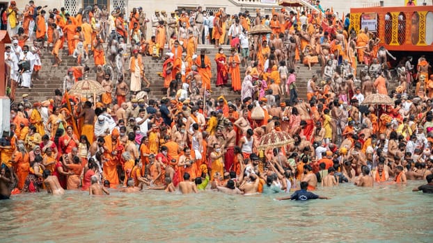 Haridwar, Uttarakhand India April 06, 2021. A Dip of Spirituality and faith, Maha Kumbh 2021. Morning Time dip, Indian saints batting in Ganges of Ganga River and Worshipping their God. High-quality