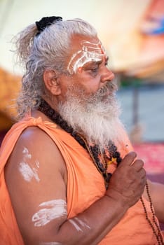 Haridwar, Uttarakhand, India April 12, 2021. Indian Saints in their traditional way of Yog Mudra, meditating. Sitting in silence as part of the initiation of new sadhus during Kumbha Mela. The Naga Sadhus.