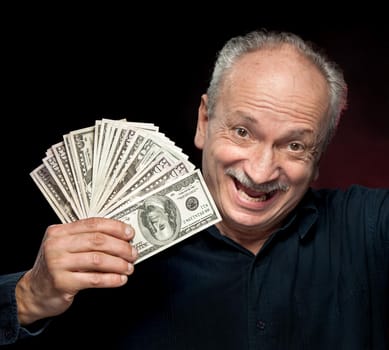 An elderly happyl businessman showing fan of money