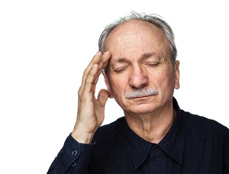 Health and illness concept. Elderly man suffers from headache and holds his head by hand isolated on white with copy space