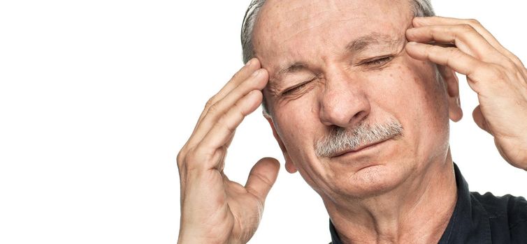 Elderly man suffering from a headache isolated on white