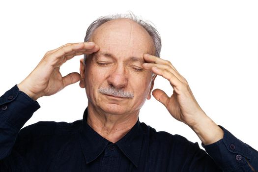 Health and illness concept. Elderly man suffers from headache and holds his head by hand isolated on white with copy space