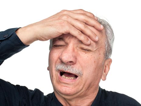 Pain. Elderly man suffering from a headache isolated on white