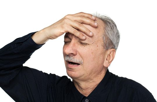 Health and illness concept. Elderly man suffers from headache and holds his head by hand isolated on white with copy space