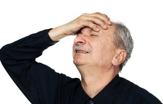 Health and illness concept. Elderly man suffers from headache and holds his head by hand isolated on white with copy space