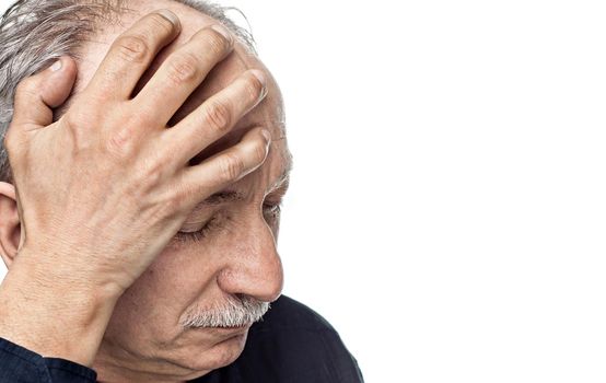 Elderly man suffering from a headache isolated on white background with copy-space