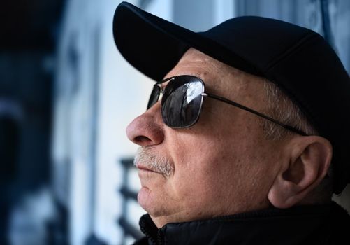 Portrait of an elderly man in profile in sunglasses