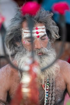 Haridwar, Uttarakhand, India April 12, 2021. Indian Saints in their traditional way of Yog Mudra, meditating. Sitting in silence as part of the initiation of new sadhus during Kumbha Mela. The Naga Sadhus.