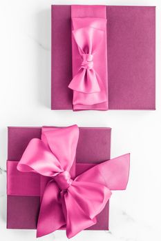 Birthday, wedding and girly branding concept - Pink gift box with silk bow on marble background, girl baby shower present and glamour fashion gift for luxury beauty brand, holiday flatlay art design