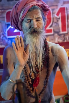 Haridwar, Uttarakhand, India April 12, 2021. Indian Saints in their traditional way of Yog Mudra, meditating. Sitting in silence as part of the initiation of new sadhus during Kumbha Mela. The Naga Sadhus.