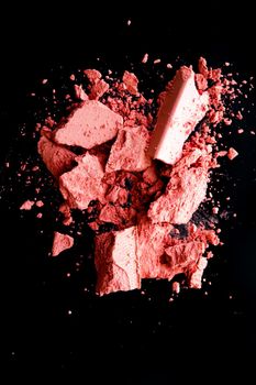 Crushed cosmetics, mineral organic eyeshadow, blush and cosmetic powder isolated on black background, makeup and beauty banner, flatlay design.