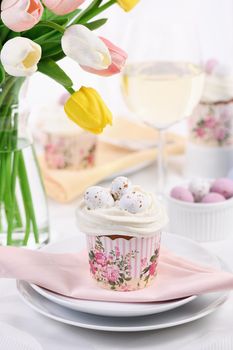 Bird's Nest Easter dessert. The muffin is decorated like a bird's nest of buttercream with quail eggs candy.