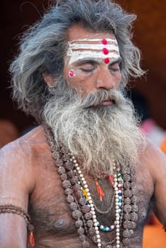 Haridwar, Uttarakhand, India April 12, 2021. Indian Saints in their traditional way of Yog Mudra, meditating. Sitting in silence as part of the initiation of new sadhus during Kumbha Mela. The Naga Sadhus.