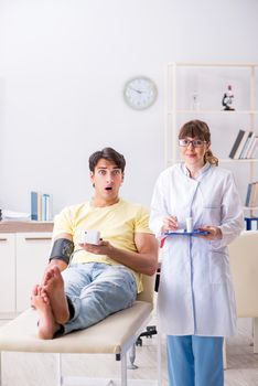 Young doctor checking patients blood pressure