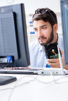 Technician with broken hard drive