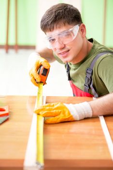 Young man carpenter working in workshop 