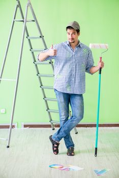 Young painter doing renovation at home 