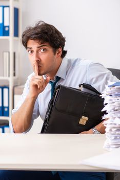 Overloaded busy employee with too much work and paperwork