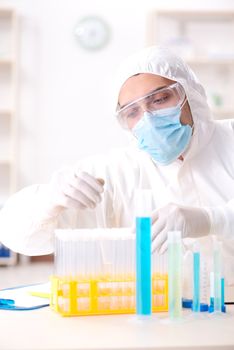 Young chemist student working in lab on chemicals
