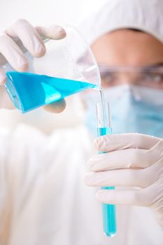 Young chemist student working in lab on chemicals