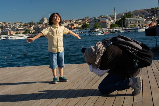 Young girl taking  photo of  boy with Istanbul panorama behind
