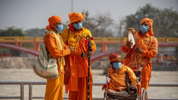 Haridwar, Uttarakhand.India- March 05 2021- Indian saints at largest gathering festival Kumbh mela at Haridwar, Uttarakhand, India playing music, wearing Coronavirus protection mask, Appleprores422 4k Cinetone High quality 4k footage