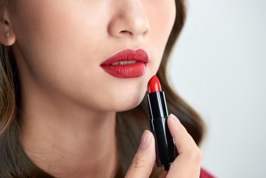 close up of beauty skincare woman take lipstick on the white background