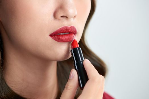 close up of beauty skincare woman take lipstick on the white background