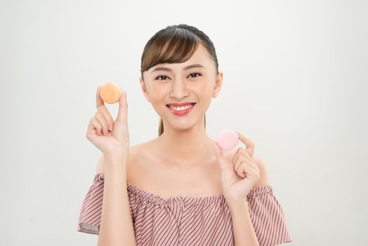 Portrait of happy Asian woman holding Macaroons