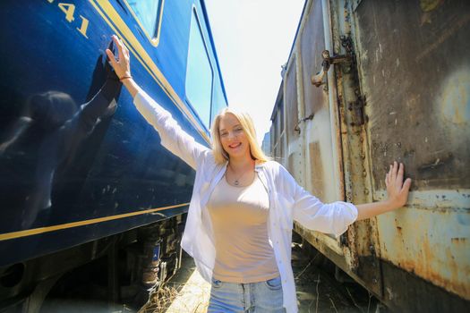 young woman waiting in vintage train, relaxed and carefree at the station platform in Bangkok, Thailand before catching a train. Travel photography. Lifestyle.