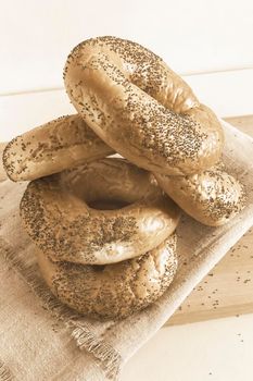 Some delicious bagels with poppy seeds on a napkin close-up. Front view.