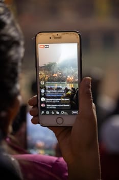 Man capturing Ganga Arti in mobile phone camera at Haridwar Uttarakhand India. High-quality photo