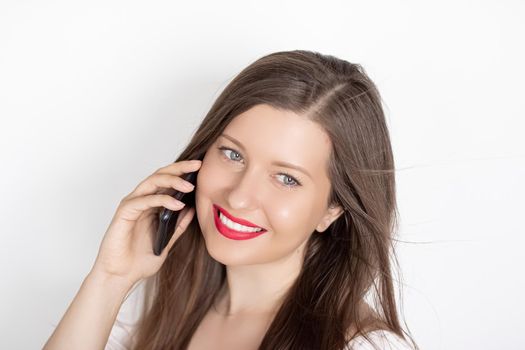 Happy smiling woman calling on smartphone, portrait on white background. People, technology and communication concept.