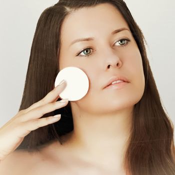 Suntan skin tone and beauty routine. Beautiful brunette female model with natural tan, face portrait of young woman.