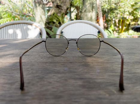 Eyeglasses on old wooden table, stock photo