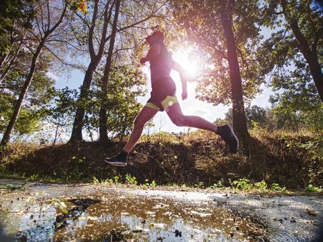 Recreation run during a sports activities in the open air forest. Summer running workout in health care and competition concept