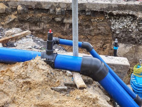 HDPE plastic tubes for drink water. Reneval potable water system in the city. Laying drink water pipe at the corner of a flat house