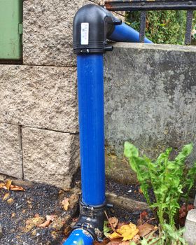 HDPE blue tube connected by black bent part  to city drinking water supply system.