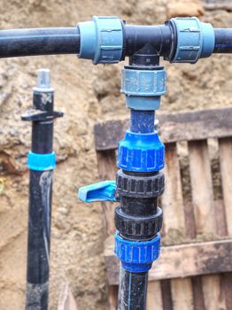 Three way joint of the PVC pipe. Potable water delivery system under reconstruction