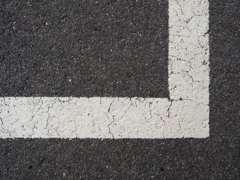 White paint line on old obsolete asphalt plaground. Empty kids areal.
