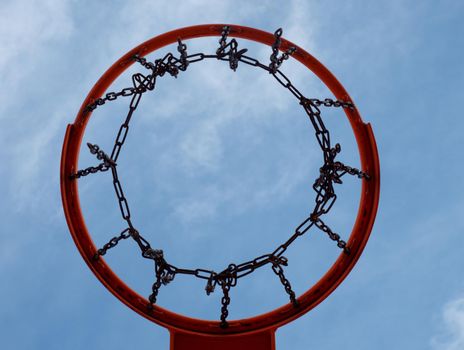 Baskerball hoop. Worn out basketball hoop on basketball court under sky