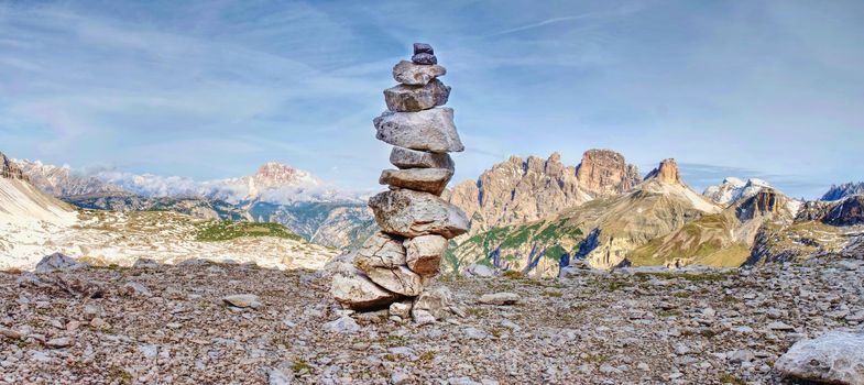 Pebbles pyramid. Stones on Alpine gravel  at Tre Cime di Lavaredo, view from tour around at April midday, Dolomite Alps Italy