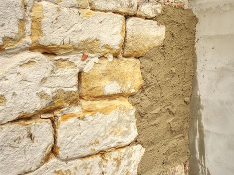 Natural stone wall, sandstone texture. Using of historical soft sand stones prepare for rebuilding of old house.