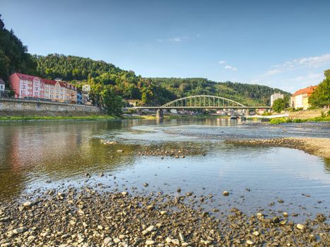 Dry riverbed of river Elbe in Decin, Czech Republic, summer 2018. Empty river bed with poisoned muddy water. Decin castle above old railway bridge.